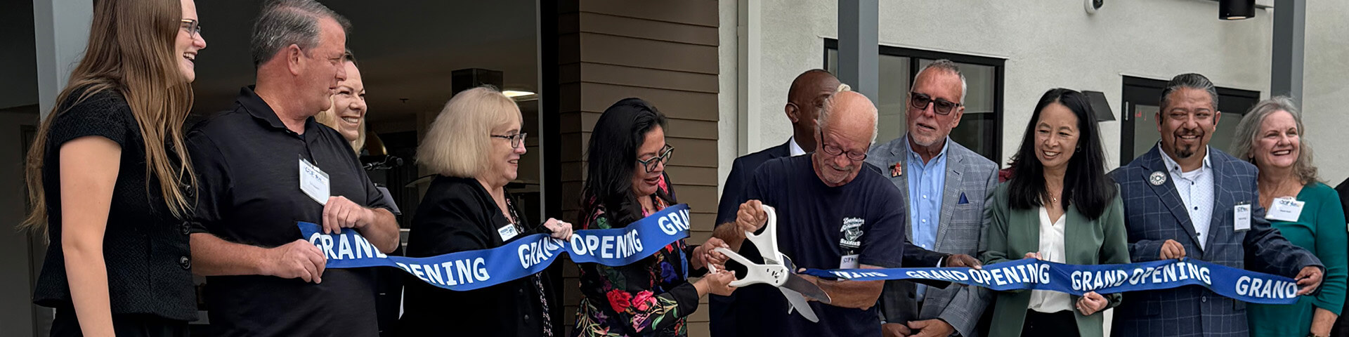 community leaders cutting ribbon for new housing development